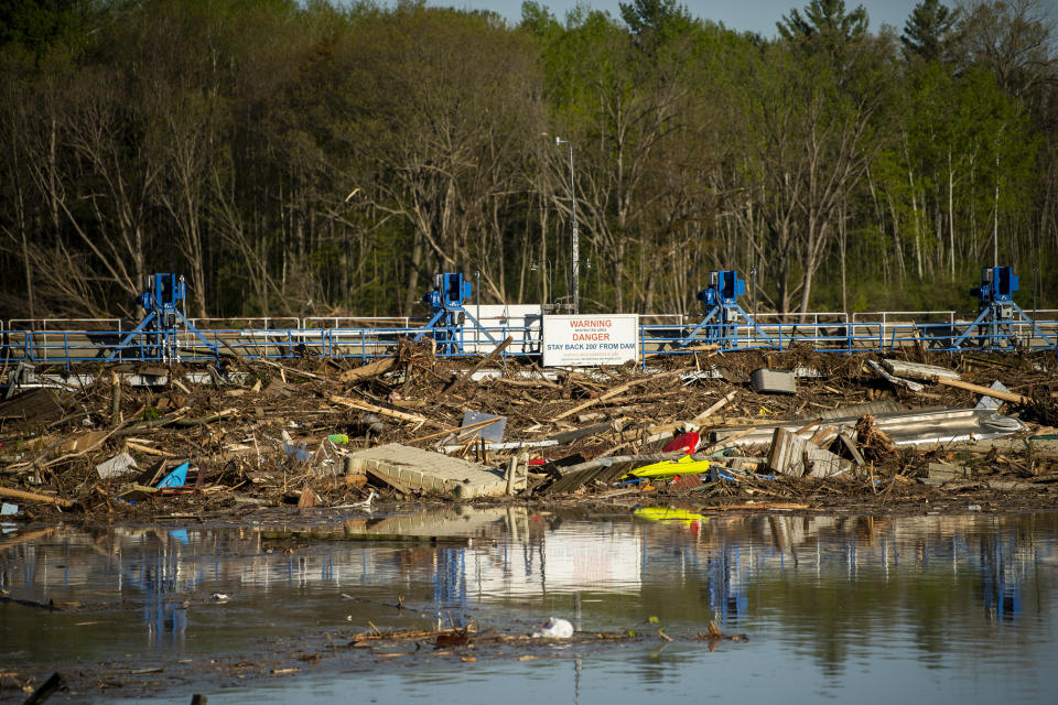 A look at the debris collected at the Sanford Dam on Wednesday, May 20, 2020. After the Edenville Dam failed and the Tittabawassee River flooded surrounding areas, many residents were urged to leave their homes and to brace themselves for the possibility of the Sanford Dam collapsing. Water flowed over the top of it through the night, but the structure is still in place. (Kaytie Boomer/The Bay City Times via AP)