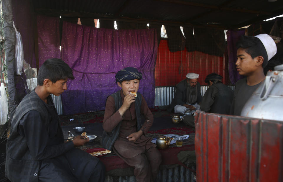 Afghans have breakfast at a local restaurant at a market in Kabul, Afghanistan, Tuesday, Aug. 6, 2019. (AP Photo/Rafiq Maqbool)