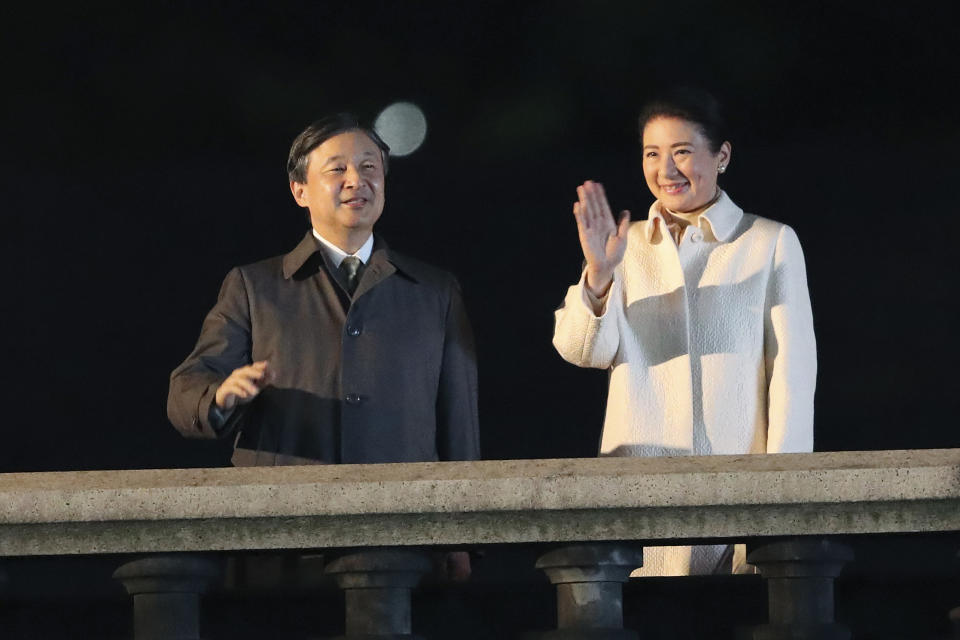 Japanese Emperor Naruhito and Empress Masako wave as they make a public appearance during a ceremony to mark his enthronement in Tokyo Saturday, Nov. 9, 2019. Naruhito thanked tens of thousands of well-wishers who gathered outside the palace to congratulate his enthronement at the ceremony organized by conservative political and business groups. (AP Photo/Koji Sasahara, Pool)