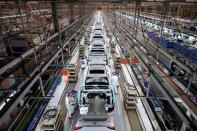 Employees work on a production line inside a Dongfeng Honda factory in Wuhan