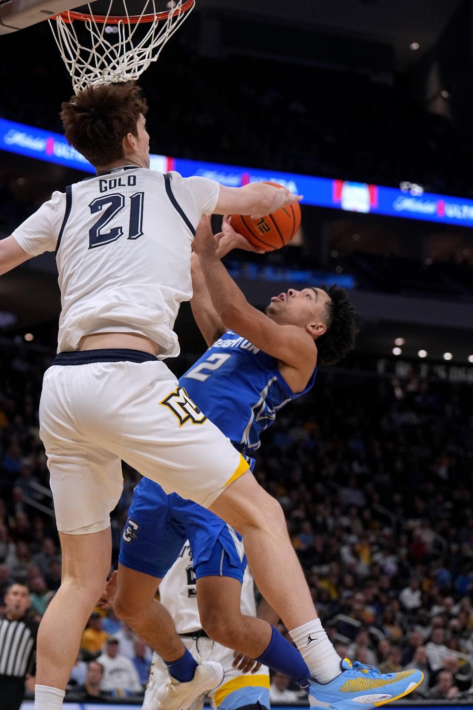 Marquette forward Ben Gold blocks a shot by Creighton guard Ryan Nembhard during the second half Friday at Fiserv Forum. The Golden Eagles' aggressive defense forced Creighton into 18 turnovers.