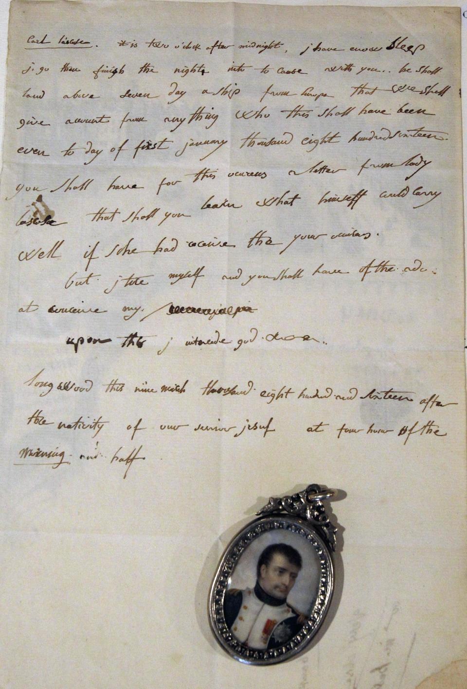 A March 9, 1816 letter written in English by French emperor Napoleon the 1st is presented, Sunday, June 10, 2012 in Fontainebleau, South of Paris, before being auctioned. The letter was sold euro 325 000, ($ 406 000). Visible in the lower part of the letter, a locket with a 1806 portrait of Napoleon by Jean Baptiste Isabey, estimated euro 22 000, ($27 000 ), was sold at the same auction. (AP Photo/Remy de la Mauviniere)