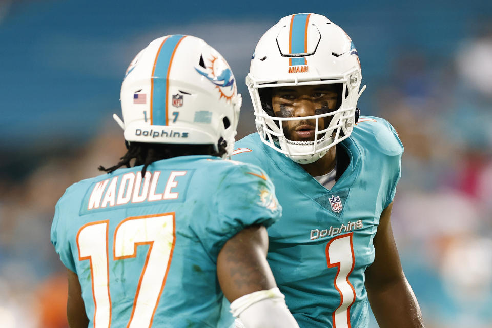 MIAMI GARDENS, FLORIDA - AUGUST 21: Tua Tagovailoa #1 and Jaylen Waddle #17 of the Miami Dolphins converse against the Atlanta Falcons during a preseason game at Hard Rock Stadium on August 21, 2021 in Miami Gardens, Florida. (Photo by Michael Reaves/Getty Images)