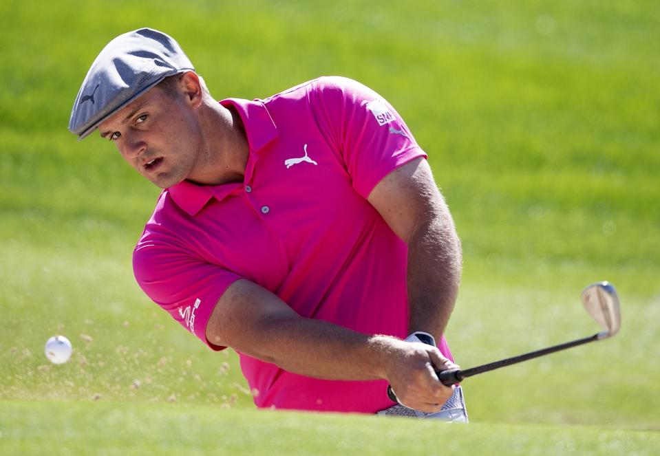 Bryson Dechambeau from the U.S. plays a bunker shot on the 2nd hole during the third round of the Dubai Desert Classic golf tournament in Dubai, United Arab Emirates, Saturday, Jan. 25, 2020. (AP Photo/Kamran Jebreili)