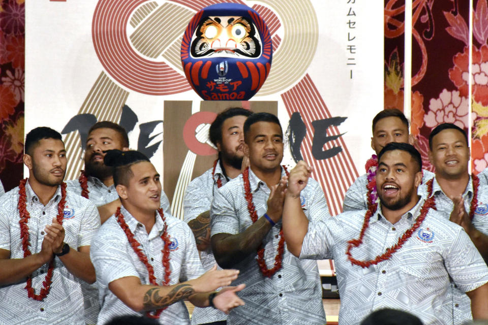 FILE - In this Sept. 16, 2019, file photo, Samoa's rugby team players perform during a welcome ceremony for their team in Yamagata, northern Japan, ahead of the Rugby World Cup in Japan. Samoan rugby players will wear skin suits to cover their traditional Pacific Islander tattoos during some training sessions at the World Cup in order not to offend their Japanese hosts.(Kyodo News via AP, File)