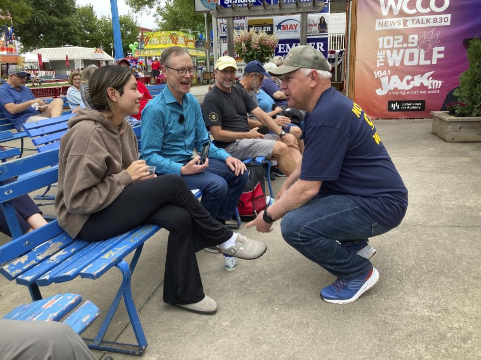 Minnesota Gov. Tim Walz chats with fairgoers on the opening day of the Minnesota State Fair on the opening day of the Minnesota State Fair on Thursday, Aug. 25, 2022, in Falcon Heights, Minn. (AP Photo/Steve Karnowski)