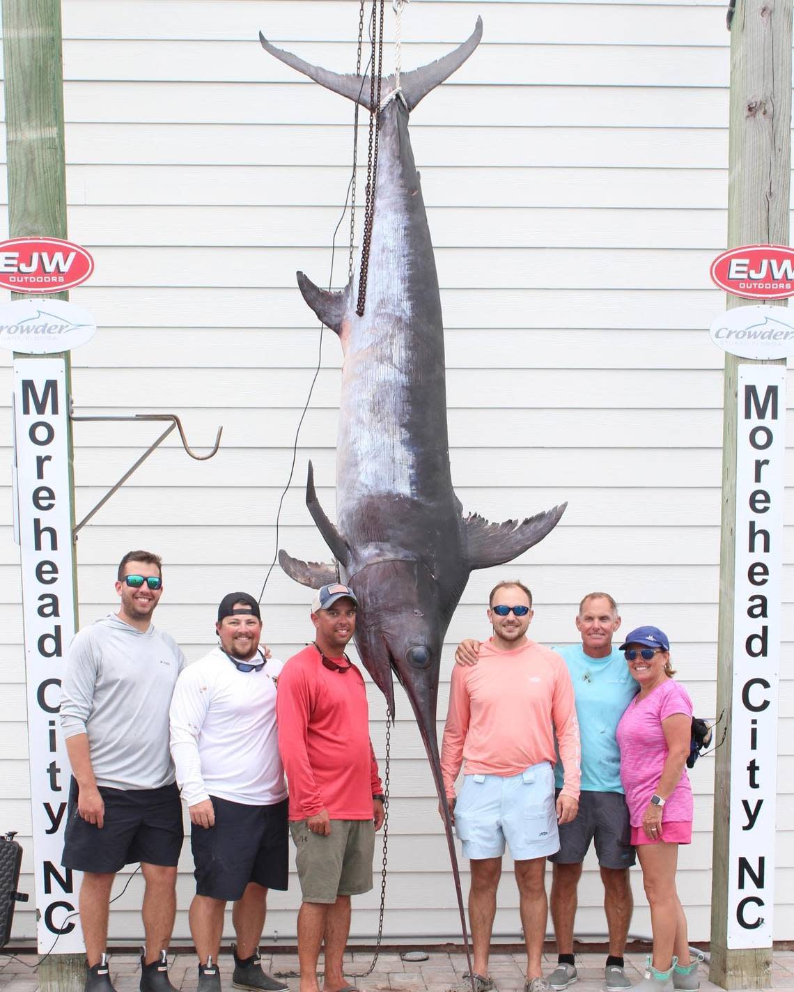 Cary Carney of Newport, NC, poses with the state-record swordfish he caught on his son Brandon Carney’s boat off Morehead City in August.