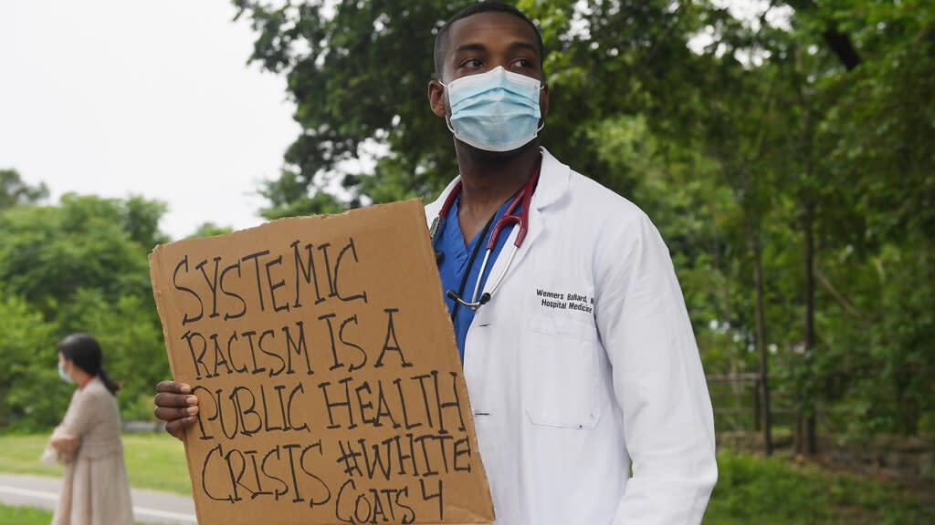 Several hundred doctors, nurses and medical professionals come together to protest against police brutality and the death of George Floyd at Barnes-Jewish Hospital on June 5, 2020 in St Louis, Missouri. (Photo by Michael B. Thomas/Getty Images)