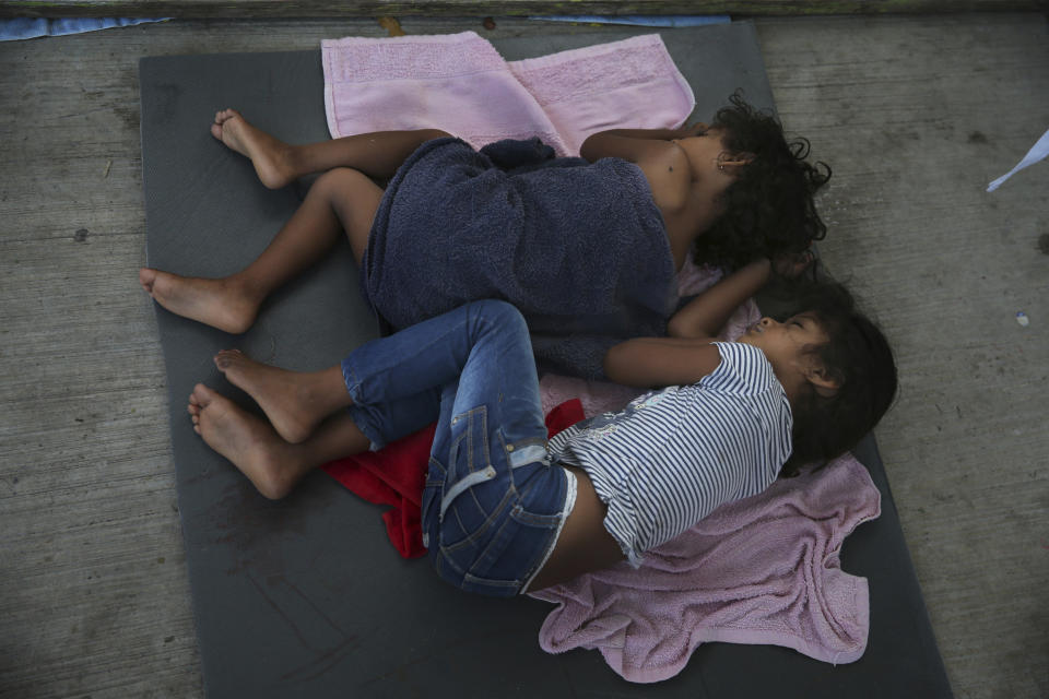 Migrant children sleep on a mattress on the floor of the AMAR migrant shelter in Nuevo Laredo, Mexico, Wednesday, July 17, 2019. Asylum-seekers grappled to understand what a new U.S. policy that all but eliminates refugee claims by Central Americans and many others meant for their bids to find a better life in America amid a chaos of rumors, confusion and fear. (AP Photo/Marco Ugarte)