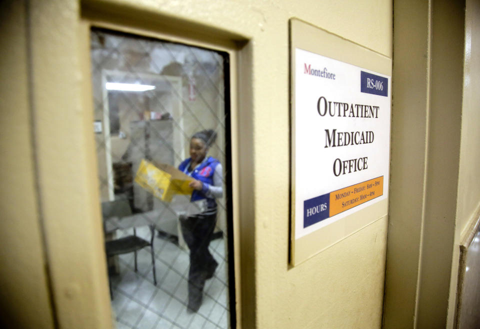 FILE - A Medicaid office employee works on reports at Montefiore Medical Center, Nov. 21, 2014, in New York. The federal government requires every state to recover money from the assets of dead people who, in their final years, relied on Medicaid for long-term care. Now, critics want the federal government to stop doing that because, they say, the program collects a bit of money from the poorest people. (AP Photo/Julie Jacobson, File)