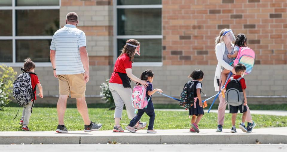Students line up to get on the bus and head home at Homecroft Elementary School, 1551 Southview Dr., Indianapolis, Wednesday, Aug. 5, 2020. 