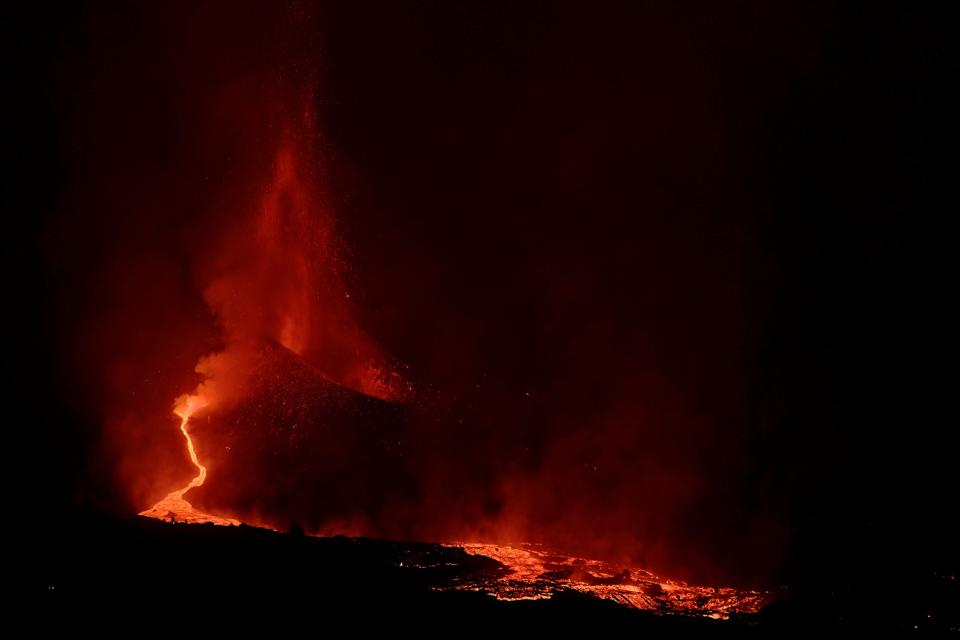 Lava spews from a volcano on the Canary island of La Palma, Spain in the early hours of Saturday Sept. 25, 2021. The prompt evacuations are credited with helping avoid casualties but scientists say the lava flows could last for weeks or months.