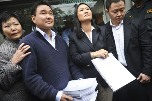 This file photo from October 10, 2012 shows Keiko Fujimori (second from R), brother Kenji (R), sister Sachi and brother Hiro presenting a petition for their father's release from prison; he remains behind bars but since-jailed Keiko is now free