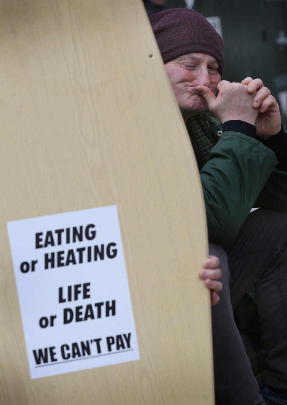 Sanctions LONDON, ENGLAND - MARCH 05: A Protester holds a coffin lid with and anti austerity message in Parliament Square on March 5, 2022 in London, England. Supporters of the People's Assembly protested against the cost of living at over 20 locations across the UK. (Photo by Martin Pope/Getty Images)