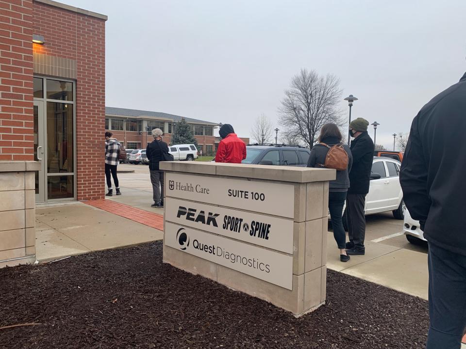 People stand in line Thursday morning at MU Health Care's walk-in COVID-19 testing clinic at 2003 W. Broadway, Suite 100. The line wrapped around the building by shortly after 8 a.m., when the clinic opened.