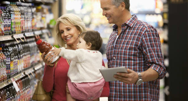 Family shopping for juice in supermarket