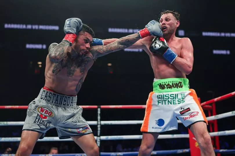 Photo showing Arnold Barboza Jr (left) and Sean McComb exchanging punches