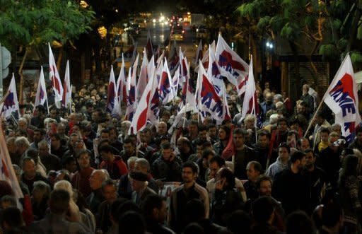 Demonstrators march to the Greek parliament in Athens, protesting against austerity measures. The Greek parliament on Sunday approved a slashed 2013 budget which the government has vowed will secure the release of foreign aid vital to save the debt-ridden country from insolvency