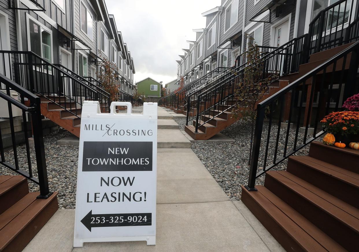 A sign points the way to a staged townhome being used as the leasing office at Mills Crossing in Bremerton on Tuesday. Mills Crossing, one of the many multi-family projects that was permitted and under construction during the pandemic, opened to renters in August.