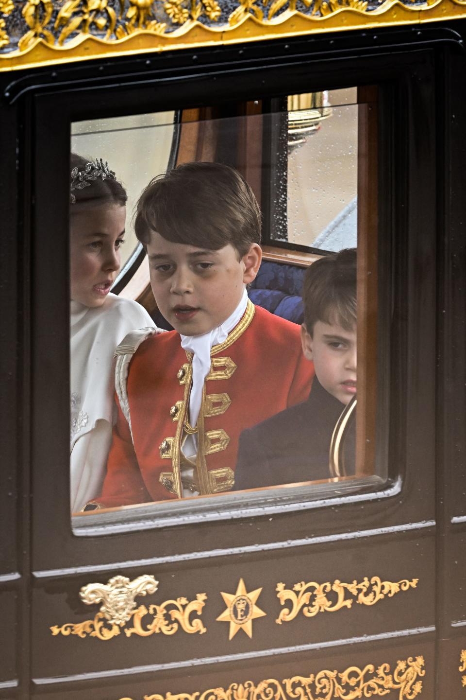 <p>Britain's Prince Louis of Wales, Britain's Prince George of Wales and Britain's Princess Charlotte of Wales travel back to Buckingham Palace from Westminster Abbey in central London on May 6, 2023, after the coronations of Britain's King Charles III and Britain's Queen Camilla. - The set-piece coronation is the first in Britain in 70 years, and only the second in history to be televised. Charles will be the 40th reigning monarch to be crowned at the central London church since King William I in 1066. (Photo by Oli SCARFF / AFP) (Photo by OLI SCARFF/AFP via Getty Images)</p> 