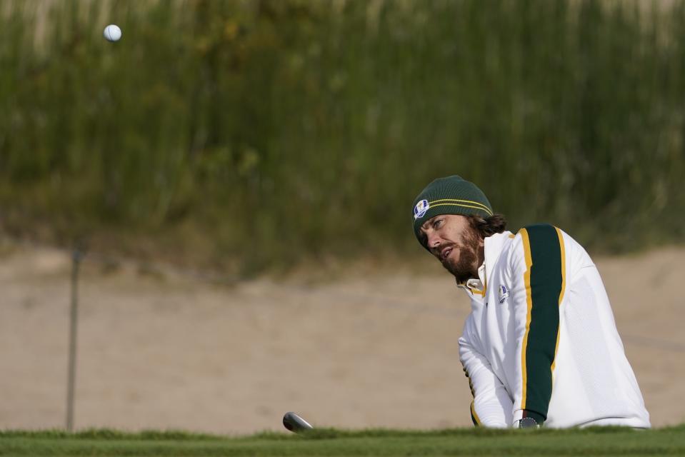 Team Europe's Tommy Fleetwood hits from a bunker on the first hole during a practice day at the Ryder Cup at the Whistling Straits Golf Course Wednesday, Sept. 22, 2021, in Sheboygan, Wis. (AP Photo/Jeff Roberson)