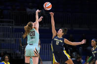 New York Liberty guard Sabrina Ionescu (20) has her shot blocked by Dallas Wings guard Veronica Burton (12) during the first half of a WNBA basketball game in Arlington, Texas, Wednesday, Aug. 10, 2022. (AP Photo/Tony Gutierrez)