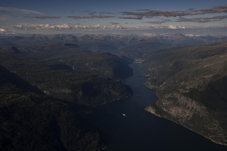 A boat sails through the fjords outside Voss, Norway, on Sept. 27, 2022. (AP Photo/Bram Janssen)