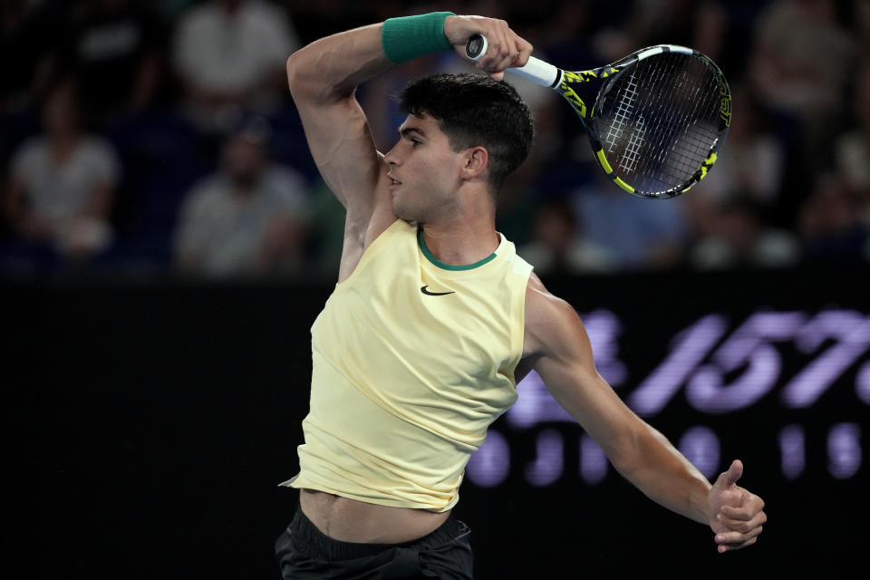 Carlos Alcaraz of Spain plays a forehand return to Richard Gasquet of France during their first round match at the Australian Open tennis championships at Melbourne Park, Melbourne, Australia, Tuesday, Jan. 16, 2024. (AP Photo/Andy Wong)