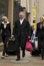 Barry Roux, the lawyer defending Oscar Pistorius, center, with his team arrives at the high court in Pretoria, South Africa, Tuesday, March 11, 2014. Pistorius is charged with murder for the shooting death of his girlfriend, Reeva Steenkamp, on Valentines Day in 2013. (AP Photo/Themba Hadebe)