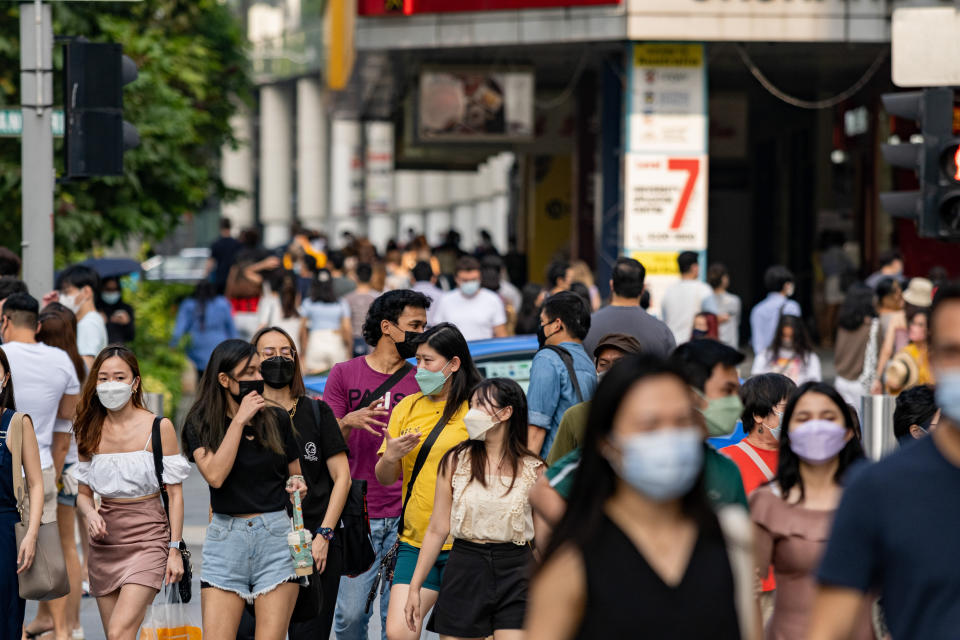 SINGAPORE - 2022/03/26: People are wearing face masks as a preventive measure against the spread of covid-19 while walking along Orchard Road, a famous shopping district in Singapore. (Photo by Maverick Asio/SOPA Images/LightRocket via Getty Images)