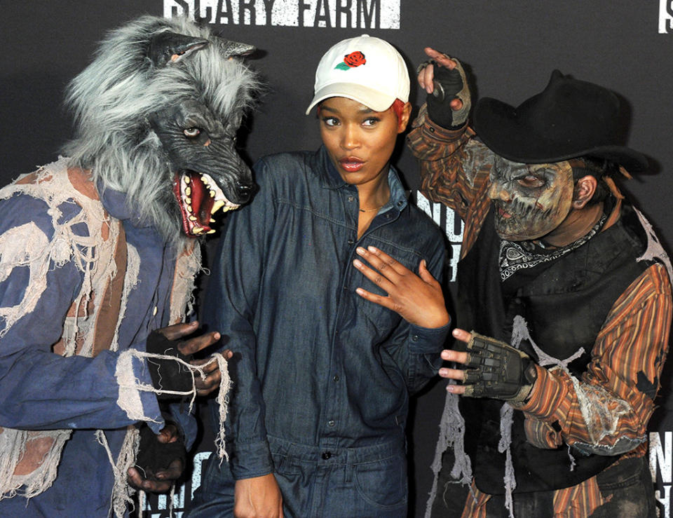 <p>Ditto for Vanessa’s <i>Grease: Live</i> co-star Keke Palmer, who managed to strike a fierce pose on the black carpet while flanked by this spooky duo. (Photo: Gregg DeGuire/WireImage) </p>