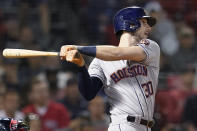 Houston Astros' Kyle Tucker follows through on a three-run double against the Boston Red Sox during the fifth inning of a baseball game at Fenway Park, Thursday, June 10, 2021, in Boston. (AP Photo/Elise Amendola)