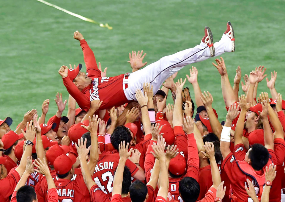 Koichi Ogata (top C), manager of the Hiroshima Carp, is tossed into the air by team members after the team clinched their first Central League championship since 1991 with a 6-4 win over the Yomiuri Giants at Tokyo Dome stadium in Tokyo, Japan, in this photo taken by Kyodo September 10, 2016. Mandatory credit Kyodo/via REUTERS ATTENTION EDITORS - THIS IMAGE WAS PROVIDED BY A THIRD PARTY. EDITORIAL USE ONLY. MANDATORY CREDIT. JAPAN OUT. NO COMMERCIAL OR EDITORIAL SALES IN JAPAN.