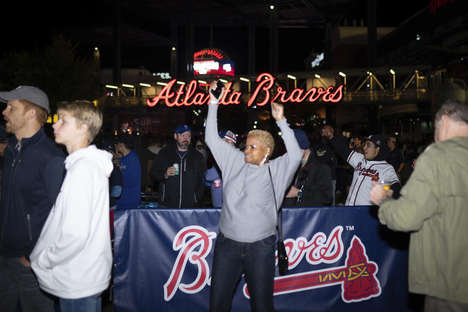 Atlanta Braves fans celebrate near Truist Park, Tuesday, Nov. 2, 2021, in Atlanta. The Atlanta Braves have won their first World Series championship since 1995, hammering the Houston Astros 7-0 in Game 6. (AP Photo/Rita Harper)