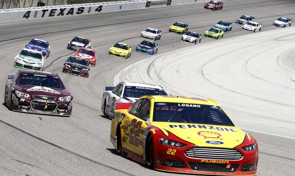 Sprint Cup Series driver Joey Logano (22) leads the pack during the NASCAR Sprint Cup series auto race at Texas Motor Speedway, Monday, April 7, 2014, in Fort Worth, Texas. (AP Photo/Mike Stone)