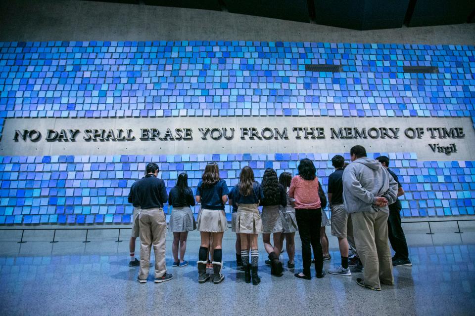 Students visiting the 9/11 Memorial & Museum stand in front of Spencer Finch's installation in 2015. The piece, symbolizing the idea of memory, comprises 2,983 individual watercolor squares – each representing a victim killed by terrorist attacks on Sept. 11, 2001, and the World Trade Center bombing in 1993.
