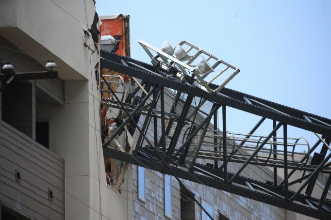 The crane resting on the damaged building in Dallas. 