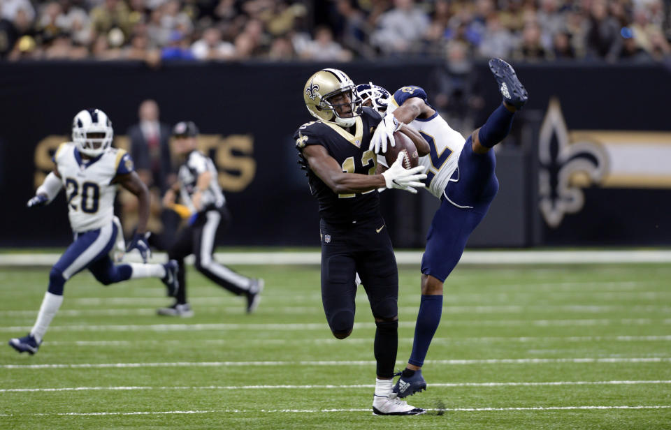 FILE - In this Nov. 4, 2018, file photo, New Orleans Saints wide receiver Michael Thomas (13) pulls in a pass against Los Angeles Rams cornerback Marcus Peters (22) during the first half of an NFL football game in New Orleans. Peters criticized himself for playing poorly when the Rams took their first loss of the season at New Orleans last weekend. That doesn’t mean Saints coach Sean Payton can say anything about it, however. Peters reacted sharply in the Rams’ locker room Thursday, Nov. 8, when asked about postgame comments by Payton in which the veteran coach said the Saints liked the matchup of receiver Michael Thomas going against Peters, a former Pro Bowl selection. (AP Photo/Bill Feig, File)