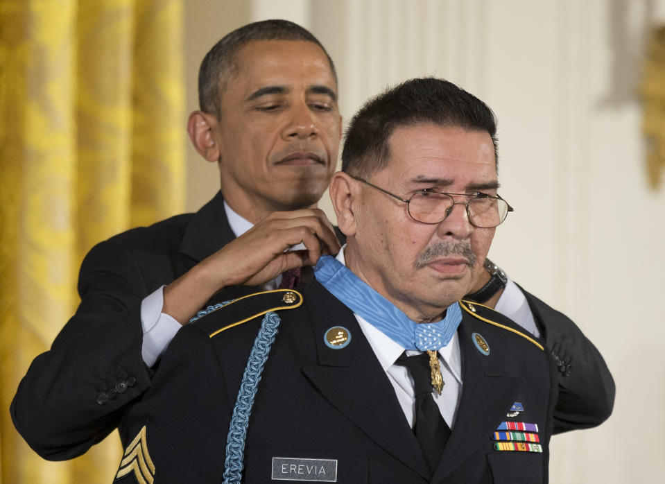 President Barack Obama awards Army Spc. Santiago Erevia the Medal of Honor during a ceremony in the East Room of the White House in Washington, Tuesday, March 18, 2014. President Obama awarded the Medals of Honor to 24 ethnic or minority U.S. soldiers who performed acts of bravery under fire in three of the nation’s wars, that were denied because of prejudice. (AP Photo/Manuel Balce Ceneta)