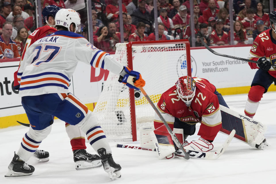 Florida Panthers goaltender Sergei Bobrovsky (72) stops a shot by Edmonton Oilers defenseman Brett Kulak (27) during the third period of Game 2 of the NHL hockey Stanley Cup Finals, Monday, June 10, 2024, in Sunrise, Fla. (AP Photo/Wilfredo Lee)