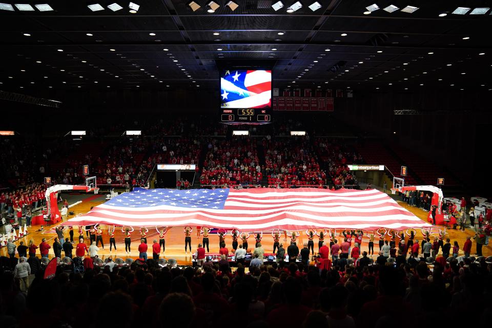 An American flag is unfurled before tip-off of an NCAA menÕs college basketball game between the Miami (Oh) Redhawks and the Cincinnati Bearcats, Wednesday, Dec. 1, 2021, at Millett Hall in Oxford, Ohio. 