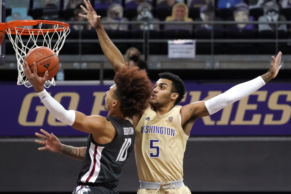 Washington's Jamal Bey (5) defends as Washington State's Isaac Bonton shoots in the first half of an NCAA college basketball game Sunday, Jan. 31, 2021, in Seattle. (AP Photo/Elaine Thompson)