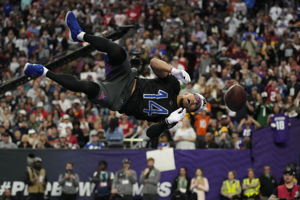 NFC wide receiver Amon-Ra St. Brown (14) of the Detroit Lions makes a catch during the best catch event at the NFL Pro Bowl, Sunday, Feb. 5, 2023, in Las Vegas. (AP Photo/John Locher)