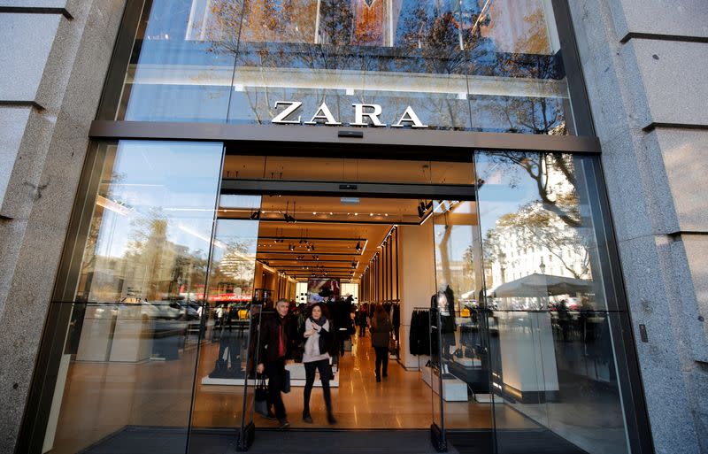 FILE PHOTO: People leave a Zara store, an Inditex brand, in central Barcelona