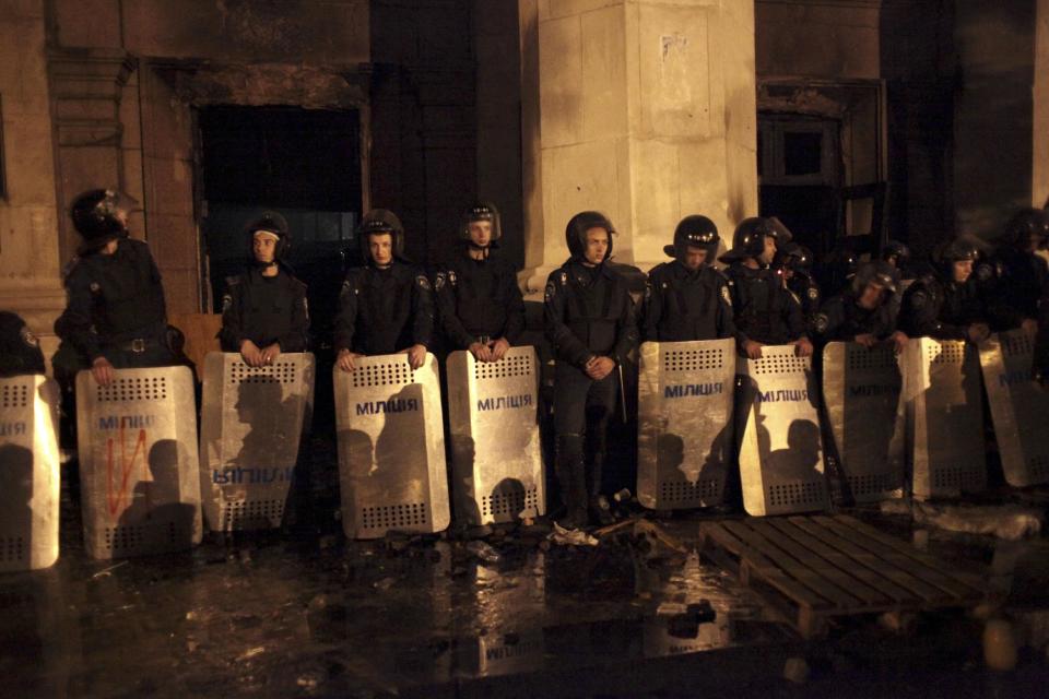 Ukrainian police guard the burnt trade union building where more than 30 people died trying to escape during clashes in Odessa, Ukraine, on Friday, May 2, 2014. Odessa had been largely tranquil since the February toppling of President Viktor Yanukovych, who fled to Russia. But clashes erupted Friday between pro-Russians and government supporters in the key port on the Black Sea coast, located 550 kilometers (330 miles) from the turmoil in the east. (AP Photo/Sergei Poliakov)