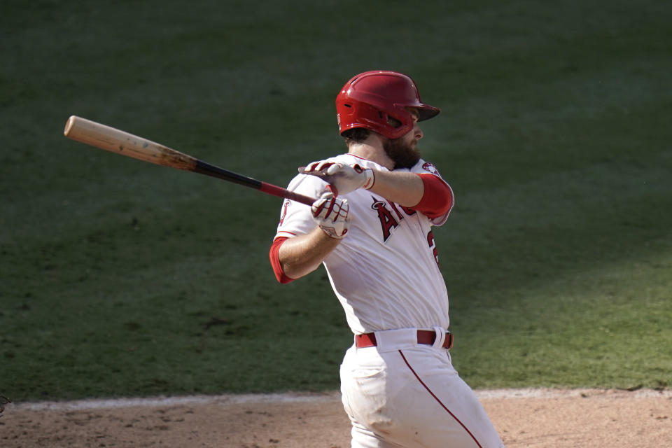 Los Angeles Angels' Jared Walsh follows through after hitting an RBI single during the eighth inning of a baseball game against the Houston Astros, Sunday, Sept. 6, 2020, in Anaheim, Calif. (AP Photo/Jae C. Hong)