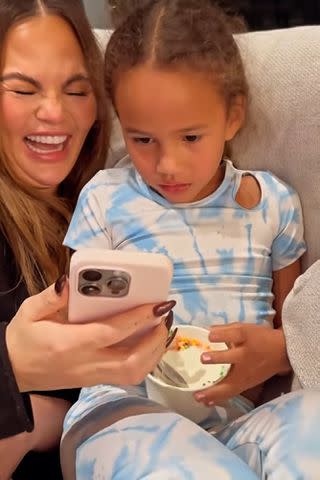 <p>Chrissy Teigen/Instagram</p> Chrissy Teigen and her daughter Luna watch a video together