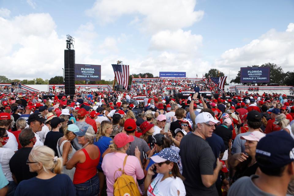 Supporters of President Donald Trump, some who are not wearing face coverings, arrive to hear his campaign speech on Thursday in Tampa, Florida.