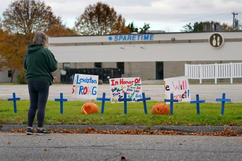 A woman visits a makeshift memorial outside Sparetime Bowling Alley, one of the site’s of the mass shooting (Copyright 2023 The Associated Press. All rights reserved.)