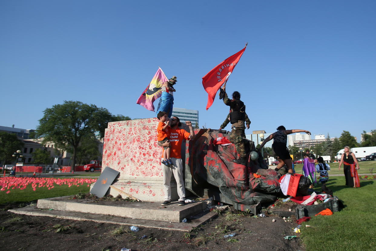 A defaced statue of Queen Victoria lies after being toppled during a rally, following the discovery of the remains of hundreds of children at former indigenous residential schools, outside the provincial legislature on Canada Day in Winnipeg, Manitoba, Canada July 1, 2021.  REUTERS/Shannon VanRaes